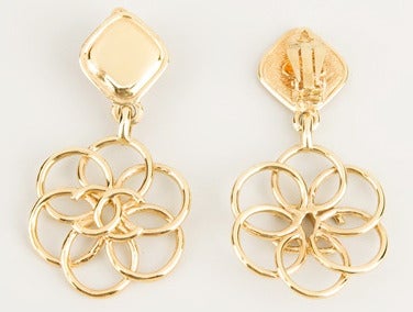Just gorgeous and in excellent condition Chanel long 'flower' cc earrings, 1980. Gold-tone 'Camelia' earrings from Chanel Vintage featuring overlapping circular sections, a central interlock signature logo and a rear clip on fastening. Marked:Chanel
