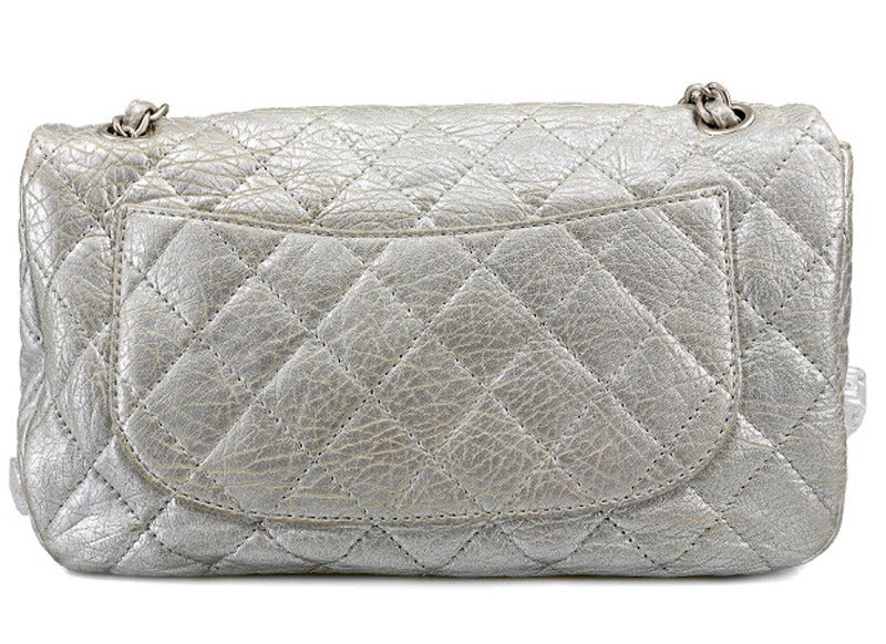 Just stunning and unique Chanel Ice Cube Jumbo Handbag of the Fall Winter collection 2010. Washed silver lambskin, Mirrored and faceted interlocking CC conceals a magnetic snap closure. Frosty resin ice cubes appear to be frozen in place on the