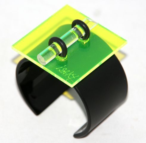 Unique Design for this geometric Bangle made by Isaky Paris, 1980. Black and yellow fluo plexi. Marked: Isaky Paris. Excellent condition. Size: Square: 5.2 cm - 2 in, width of bangle: 4 cm - 1 2/3 in, Opening: 3 cm - 1 1/5 in.