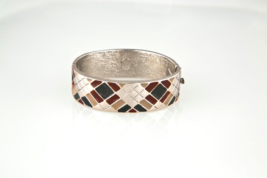 Rare early 1970?s LANVIN PARIS hinged bracelet bangle.  Cast in silvered metal this beautiful piece features a hand painted, enamel harlequin pattern in 3 striking colors.   Comfortable oval shape won?t shift on the wrist.  Signed LANVIN PARIS on