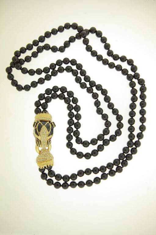 Ciner black enamel and crystal panther beaded necklace.
Known for pieces that resemble fine jewelry, this Ciner famous design is all
the more collectible because of its double stranded, opera length black
glass beads.  The beautiful large panther