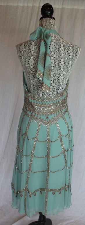 dusty aqua dress... embellished with bronze embroidery and sequins... backless halter front... ties at neckline... 3/4 length dress... silk crepe interior...