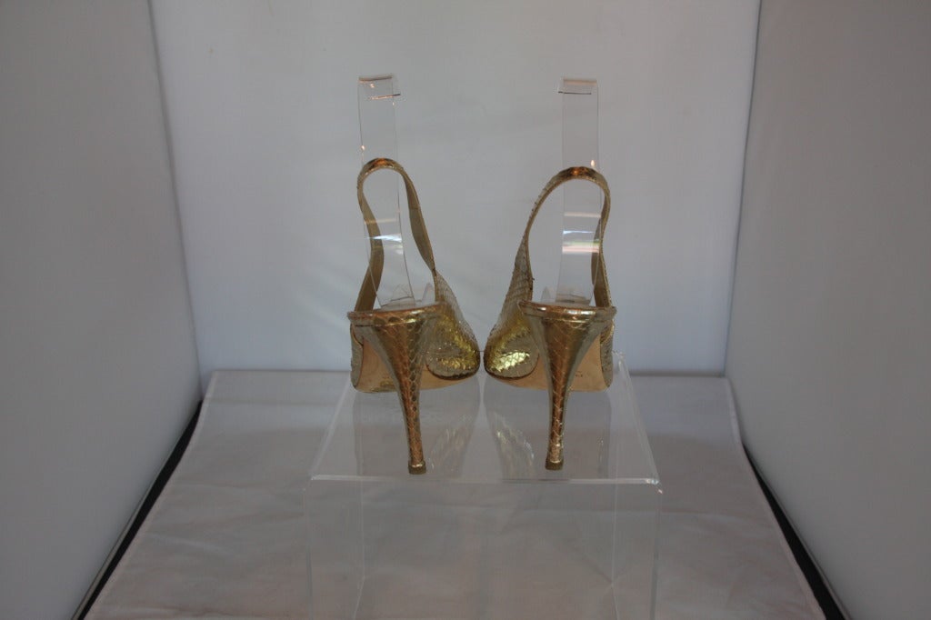 Stunning pair of snakeskin slingback heels in brilliant gold leaf.  Duster is included.