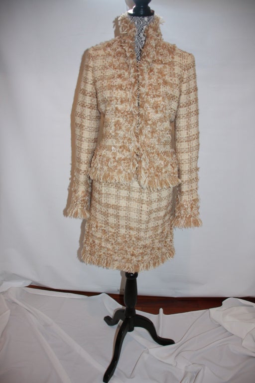 Rich looking designer skirt suit from Oscar De la Renta. Deeply textured weave in cream and amber. Suit has fringe of both colors around cuffs, collar and skirt. Neiman Marcus Label.