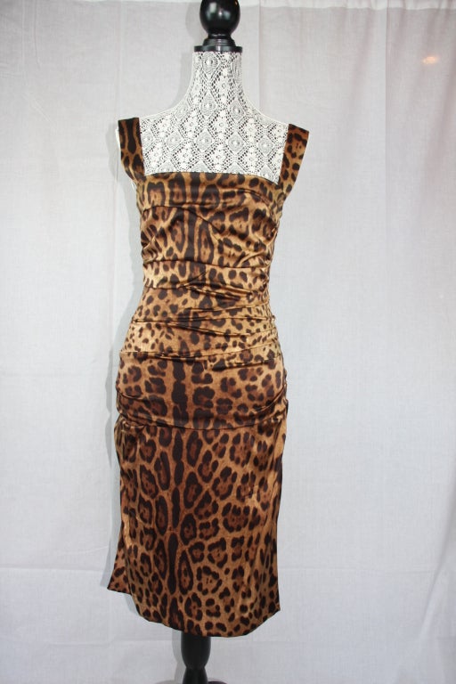 Classic still is the vision of Dolce & Gabbana with this sexy leopard print form fitting sheath dress. Great styling front and back that shows off curves. Dress is gathered slightly all around.