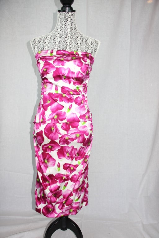 retro inspired form fitting floral print sheath dress. Bright fuschia flowers with lime green accents. This dress has interesting gather up and down front and back to really ride ones figure.