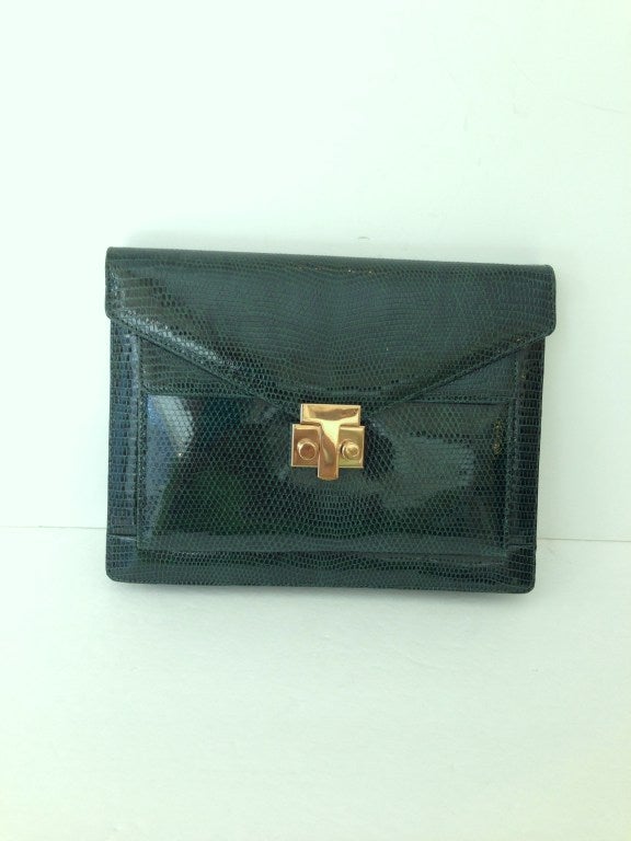 Forest green lizard envelope clutch with detachable adjustable strap
Outside pocket upon opening
Green leather lined interior
One inside zip pocket as well as an open side pocket

Perfect condition

All sales are final
Guaranteed authentic