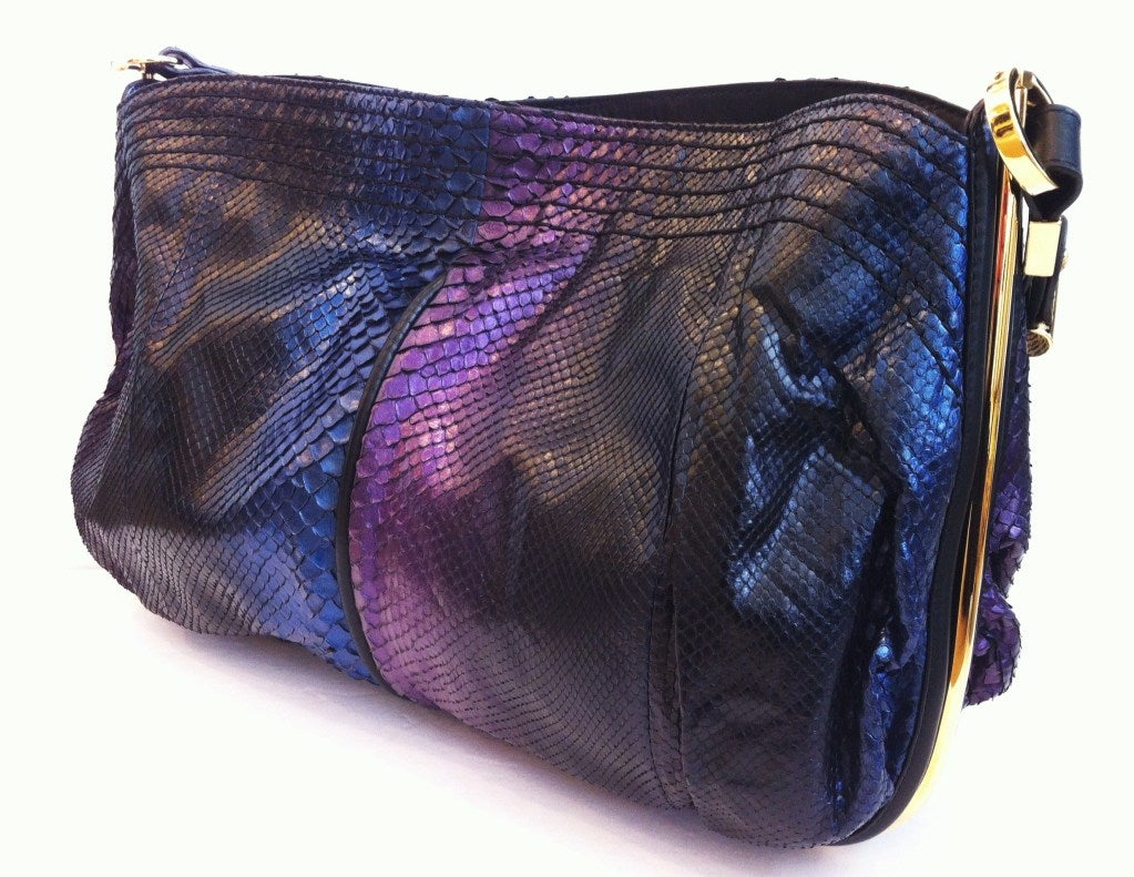 Intergalactic python. What more could a girl want?

We love the galaxy of colors: a palette that swings from violet to indigo, midnight blue to Mars black. The gold hardware and metal structured sides give it just one more unique edge. Inside is