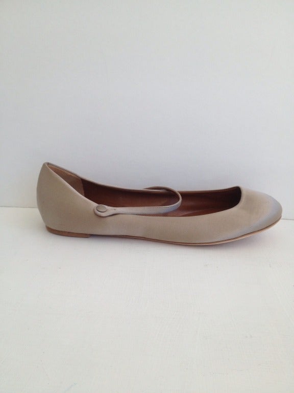 Delicate, elegant, and classically pretty. 

An elastic piece at the base of the delicate strap keeps these structured fine satin ballet flats comfortable, and prevents slipping. 

Wear them with light, gauzy neutrals or dramatically draped