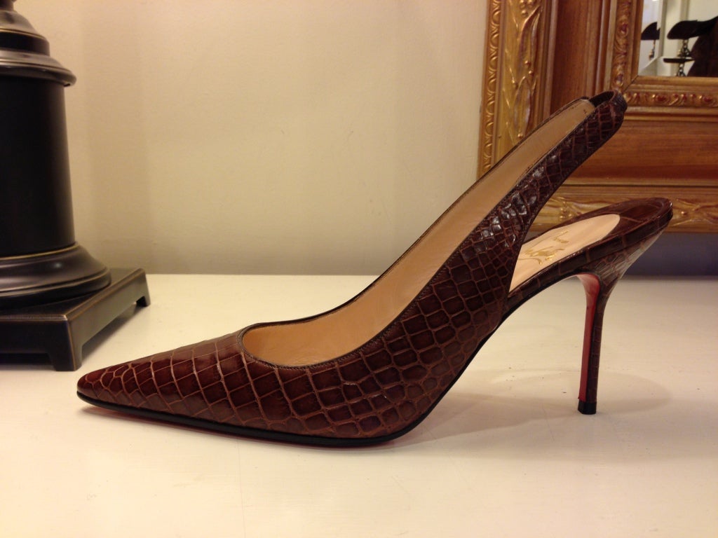 Everyone should have a pair of these classic shoes that will never go out of style.  The slingback heels are made of warm cognac colored crocodile skin and have never been worn.  Louboutin is stamped on the bottom of this iconic red-soled shoe..this