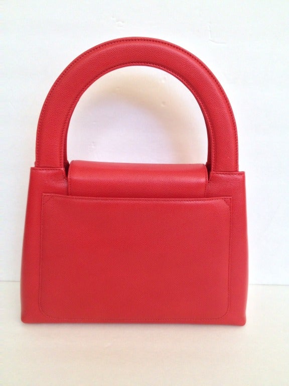 Could this bag be any more iconic?

Poppy red caviar leather is shaped into a structured, graphic bag straight from the offices of Sterling Cooper. The petite top flap is closed with a gold Chanel emblem clasp. 

Inside is lined with red leather
