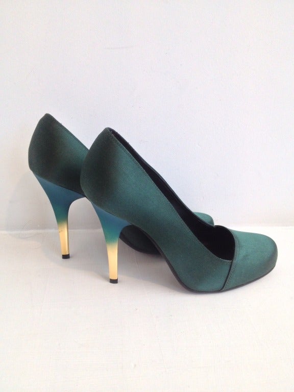 Ivy with an edge.

Classic emerald green satin pumps are given a fresh contemporary update with 4.5