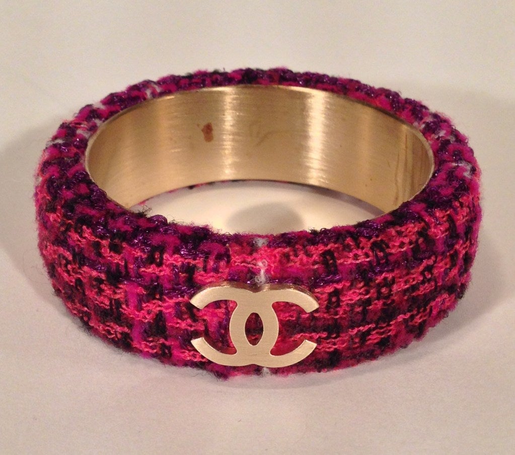 Chanel jewelry for the modern woman! This bracelet combines the classic tweed that Chanel is famous for with a hip modern twist. Three matte gold CC's decorate the exterior. From Chanel's Autumn collection 2009. Comes with original jewelry