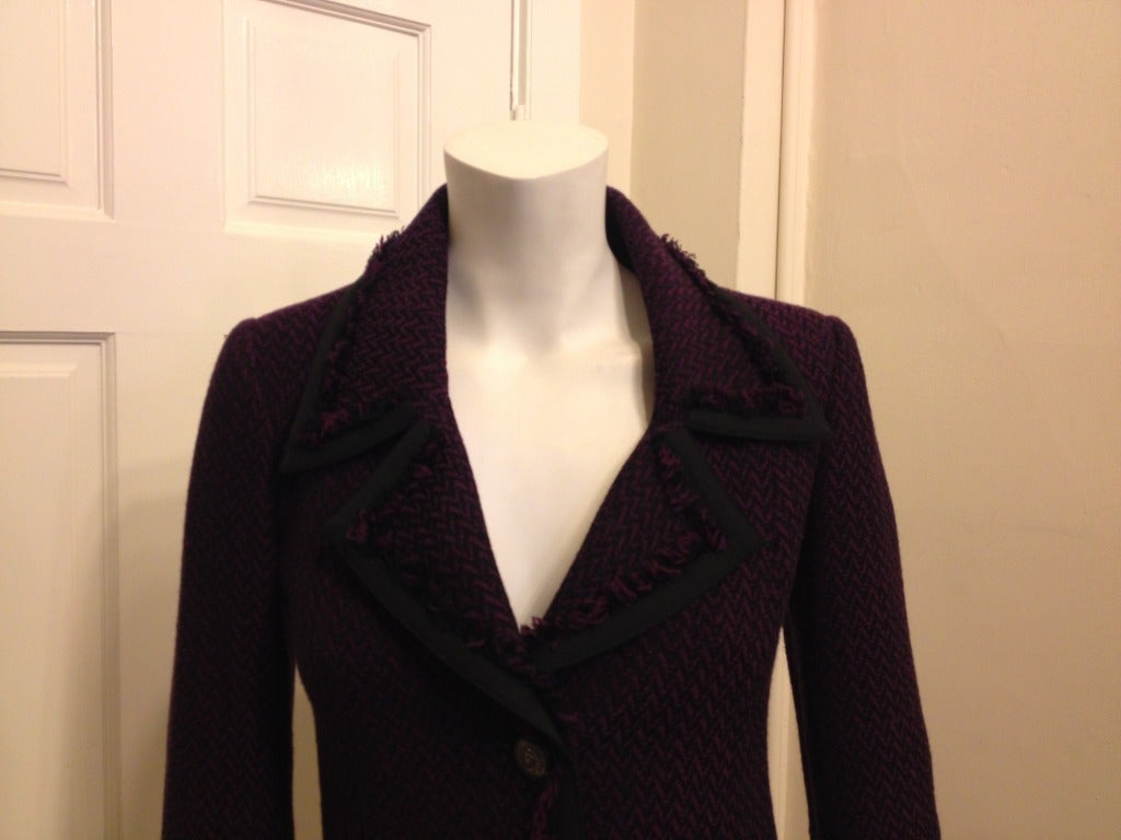 Vibrant purple pumps up this classic blazer with woven black and purple zig-zags.  Three pewter buttons close the front.  Black grosgrain ribbon trims the edges with black and purple fringe.  The interior is lined with black silk printed with
