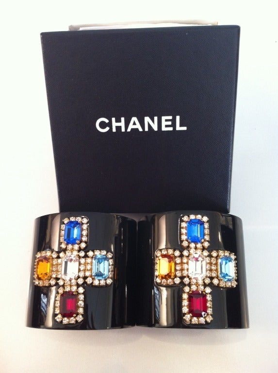 We've died and gone to heaven!  Not just one, but two matching cuffs are essential for any collector of Chanel.  Just like Coco herself used to wear!  From the spring 1995 collection, these resin bracelets feature a cross of five crystals in royal
