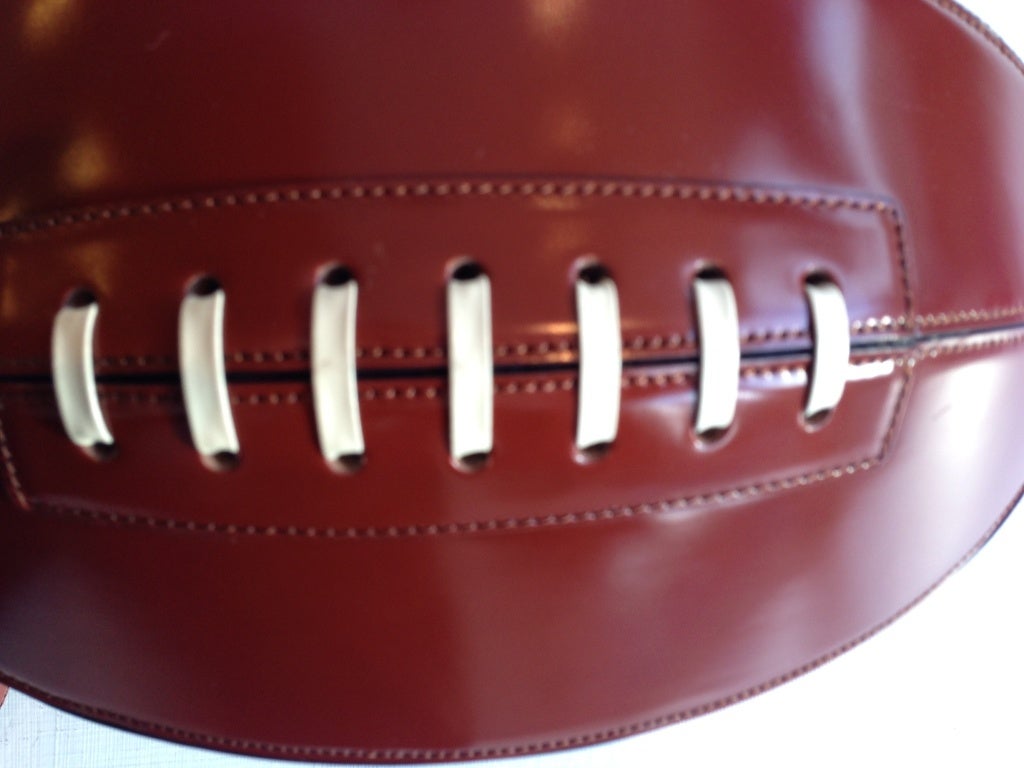 Show your hubby you REALLY care this football season. This beautifully crafted Moschino football will be the talk of the town.  There are two straps on the top,  a long detachable shoulder strap is included.  The interior is open with no added