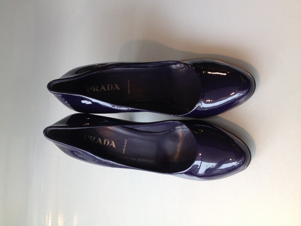 Step out in gorgeous purple patent! These Prada heels are perfect - lustrous in deep, saturated eggplant purple is sophisticated and subtly gorgeous in all seasons. These shoes are both a statement in themselves and make a beautiful complement to