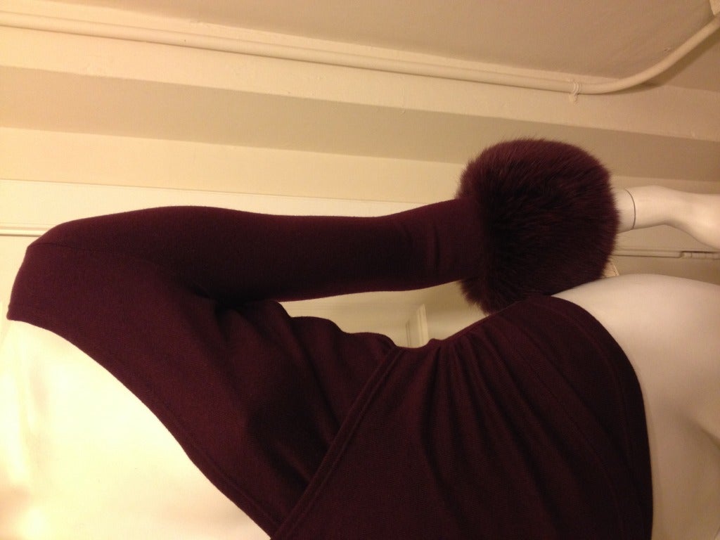 This elegant cashmere sweater is pure luxury!  Deep burgundy knit in a wrap around style is figure-flattering and shows off a bit of décolleté.  Thick, soft fox fur trims the cuffs for added extravagance.  Perfect for your apres-ski or dinner party!