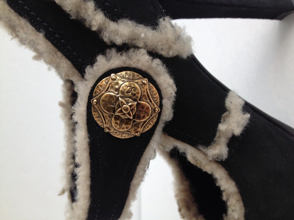 A fun twist to dress up your winter wardrobe. This classic mary jane style features a strap that closes with a snap covered by a large gold button.  Wool trim will keep you warm even where your toe peeps through!      Heel 4.25 inches

*Please