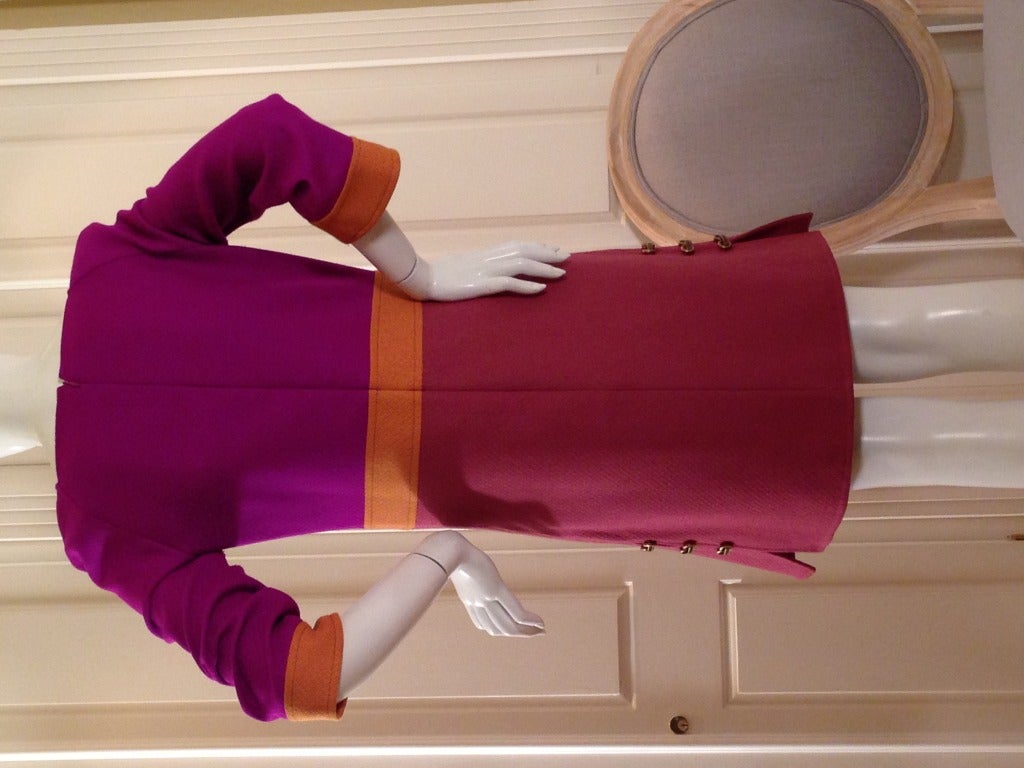This dress balances the bright colors that Pucci is known for with a sophisticated color-block pattern  Bright magenta, orange and mauve make up this mod dress and give you a long flattering mid-section.  The 3/4 sleeves are perfect for any season. 