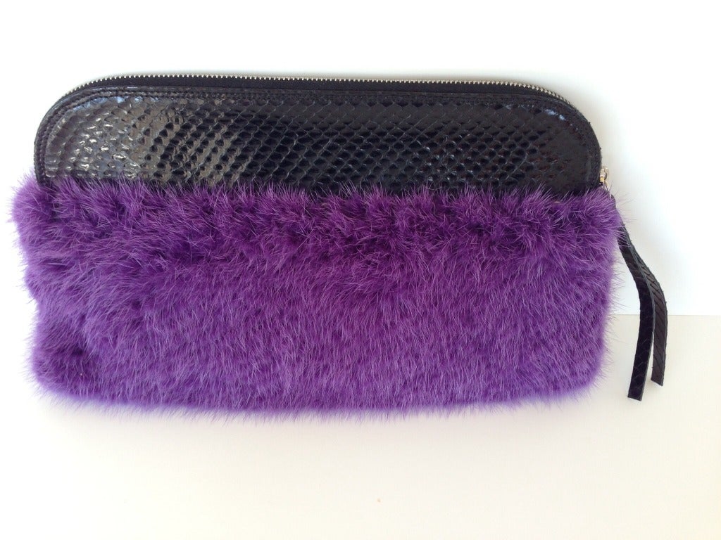 So bold! Make a statement with this gorgeous little clutch. A perfect pop of color, this will be a great accent to any outfit, whether worn with a black cocktail dress or with something bright and fun. The contrast between the dramatic purple rabbit