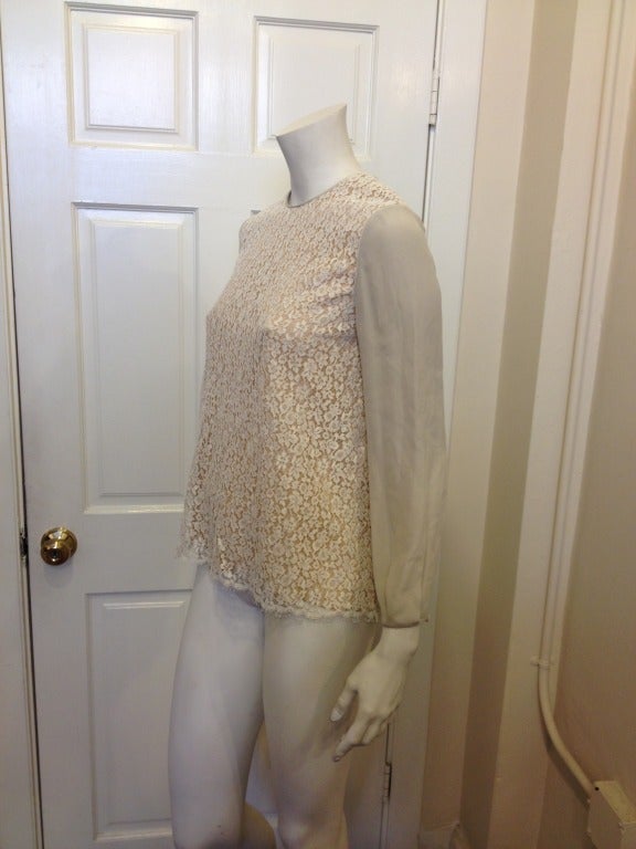 Be the prettiest girl in this Chloe top! With a champagne colored lace overlay and dove grey silk sleeves, this top will look beautiful either dressed down with black jeans and leather boots or paired with shorts and heels. Romantic, sweet, and