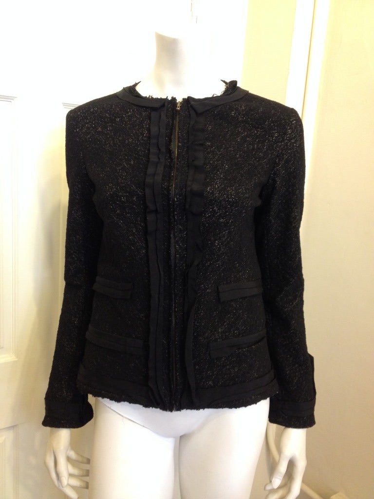 This Lanvin jacket is the missing piece from every wardrobe! Versatile, unique, and modern, it has a flattering tailored shape, a gorgeous speckled black and charcoal grey body, and modern feminine ribbon detailing. This jacket is casual enough to