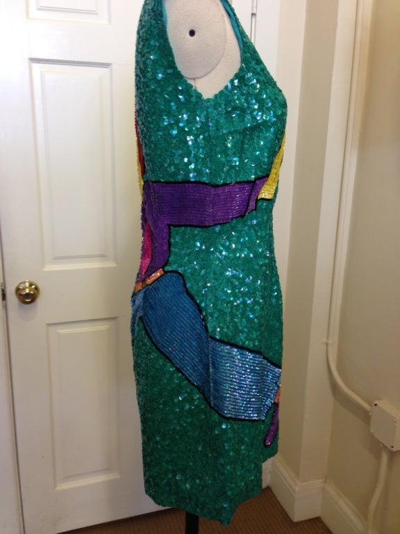 How much more whimsical can one get! A sequined heartbreaker! This vintage Bayou will be a head turner at your next cocktail event...all green aurora borealis sequins in a swirling pattern throughout the dress...there is a cartoon man on the back