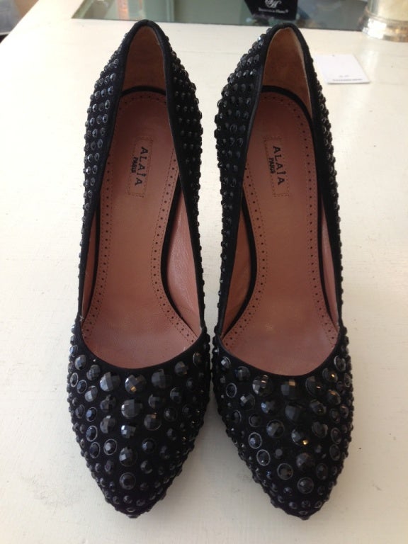Sparkle plenty!
 This amazing Alaia shoe is a compliment to any outfit. The black Swarovski crystals are mounted all over the black suede shoe in a range of sizes. The size of the crystals range from 1/8