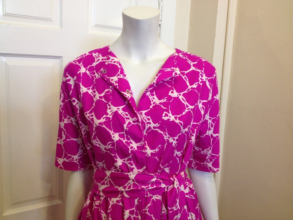 Bold and beautiful!  This Balenciaga dress is perfection.  Bright pink print makes a statement and the cut of the dress is flattering in every way.  The sleeves come just to your elbow and the belt shows off your waistline.  The neckline gently