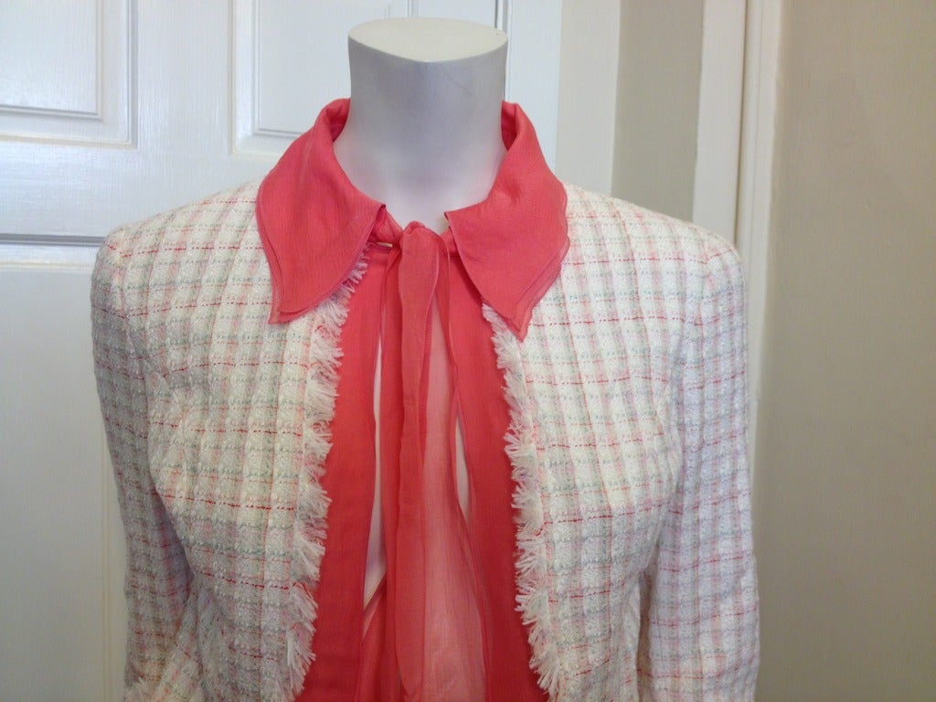 Look like a lady in this flirty, feminine jacket!  White tweed is brightened up with thin lines of pink, red, and green woven into this fabulous piece.  The unfinished edges of the jacket contrast the prim look of the pink silk.  Three layers of