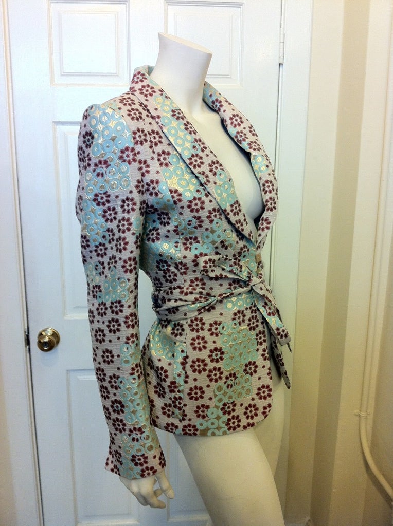 Spring has sprung!  This jacket is the perfect piece for spring and summer events.  Beautiful light blue contrasts the maroon floral pattern.  Three buttons close the jacket and the long sash wraps around the back to tie in front to show off your