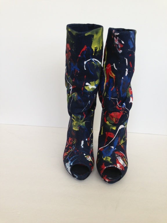 McQueen meets Pollack....and this fabulous colorful paint splattered boot is the result! Perfect with your favorite jeans or leggings! Scrunched down or not, the it pair of boots to add to your collection. The open toe lets you add your color to