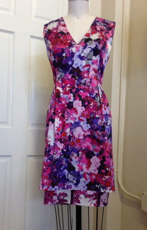 Shades of pink and purple, flowers in bloom
~V-necked dress, 2 pleats in front off of waistline
~double tier of blooms at hem
~Built in lining
~Hidden zipper in back, 2 pleats off of waistline in back as well

All sales are final.