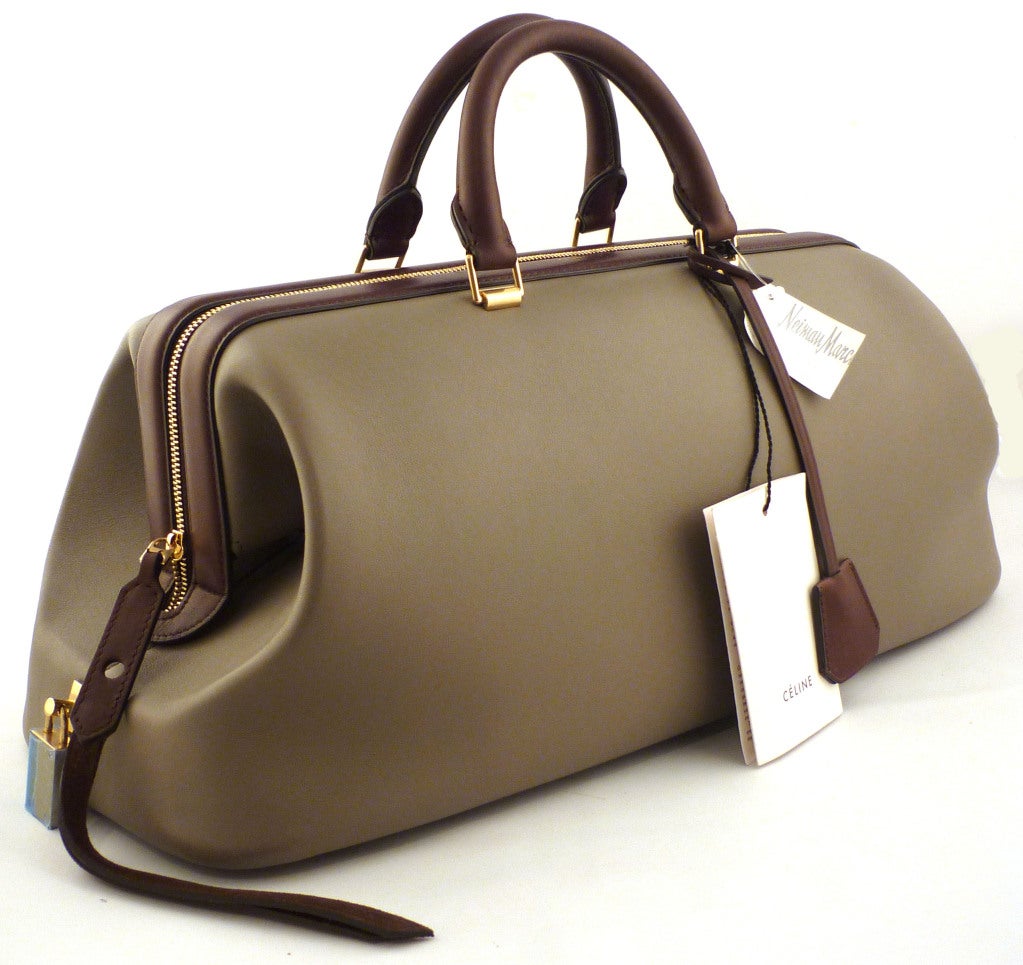 Rare! NWT! 

GORGEOUS soft leather bag. Be the most stylish gal around with this ultra sophisticated and structured bag. 

- Grey leather exterior
- Brown leather trim, handles, and interior
- Top handles with 3