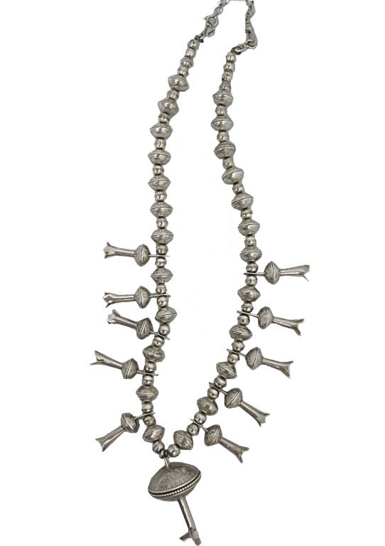 Sterling silver squash blossom necklace made in the early 1970's.  

- Height 15 1/2