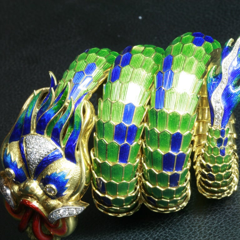 Fabulous Italian 1960's Enamel and Diamond Dragon Bracelet
This audacious statement piece is directly inspired from the East, with shiny blue and green enamel contrasted with striking 18k yellow Gold and accented with over 40 white diamonds.
