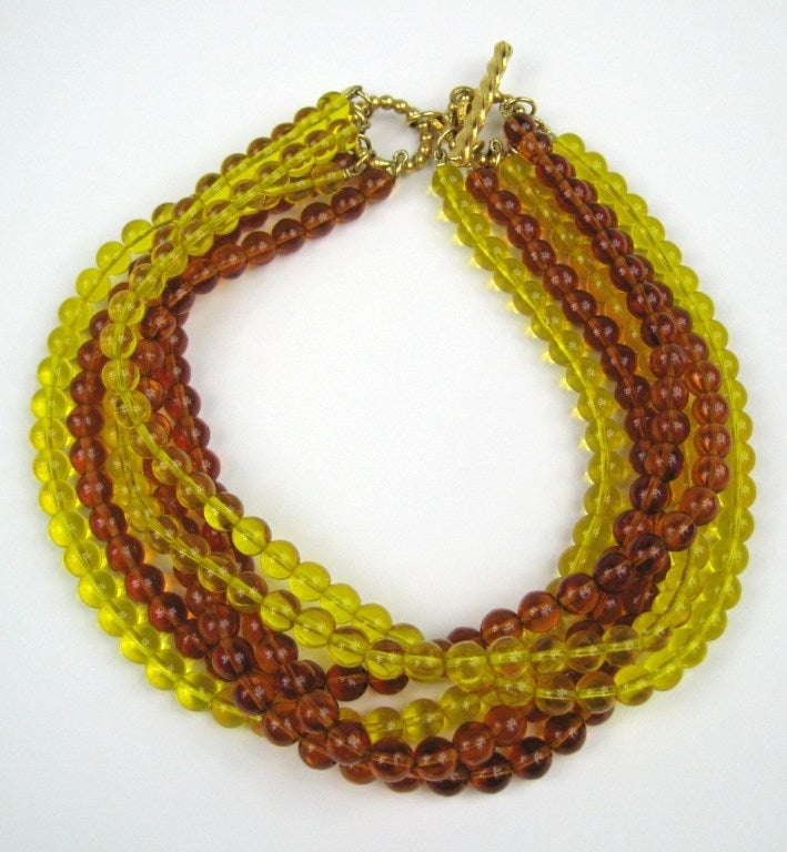 Dominique Aurientis Multi Strand Amber & Yellow Glass beaded Choker.
6 Strands, toggle closure.
New Old Stock. A massive collection of jewelry that was purchased and then stored away till now. 

Dominique Aurientis started her career in the