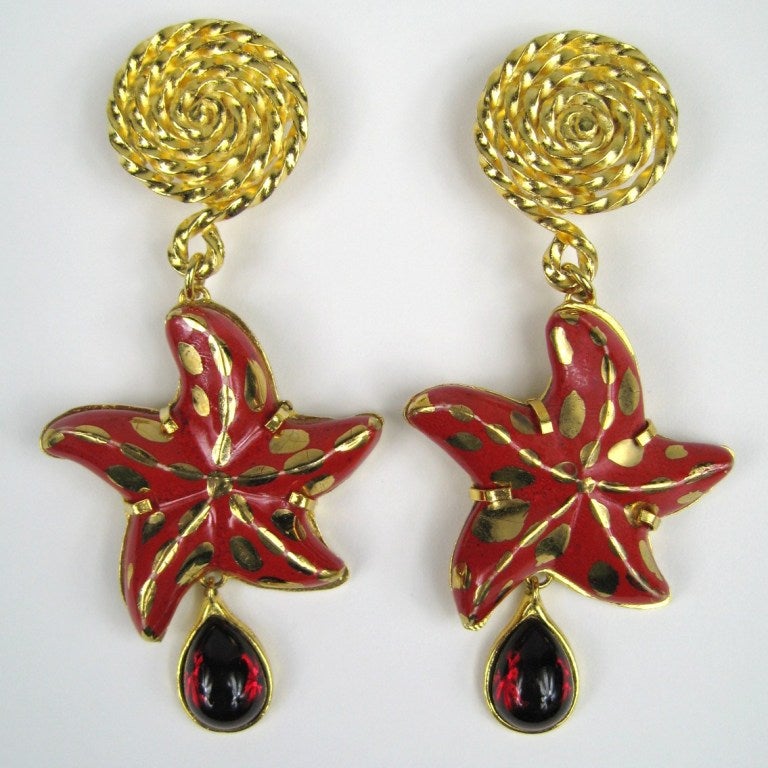 Starfish Dangles. Poured Glass teardrops. Painted Gold Detailing.
Out of a huge estate of jewelry we acquired, most of which was never worn. 
Any questions please call or hit request more information