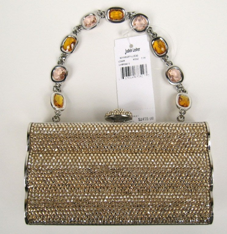 Stunning Leiber clutch. New with tags in box. This is must have to the upcoming holiday season. Shimmer in Gold. Lined is luxurious  leather.
Height 	3