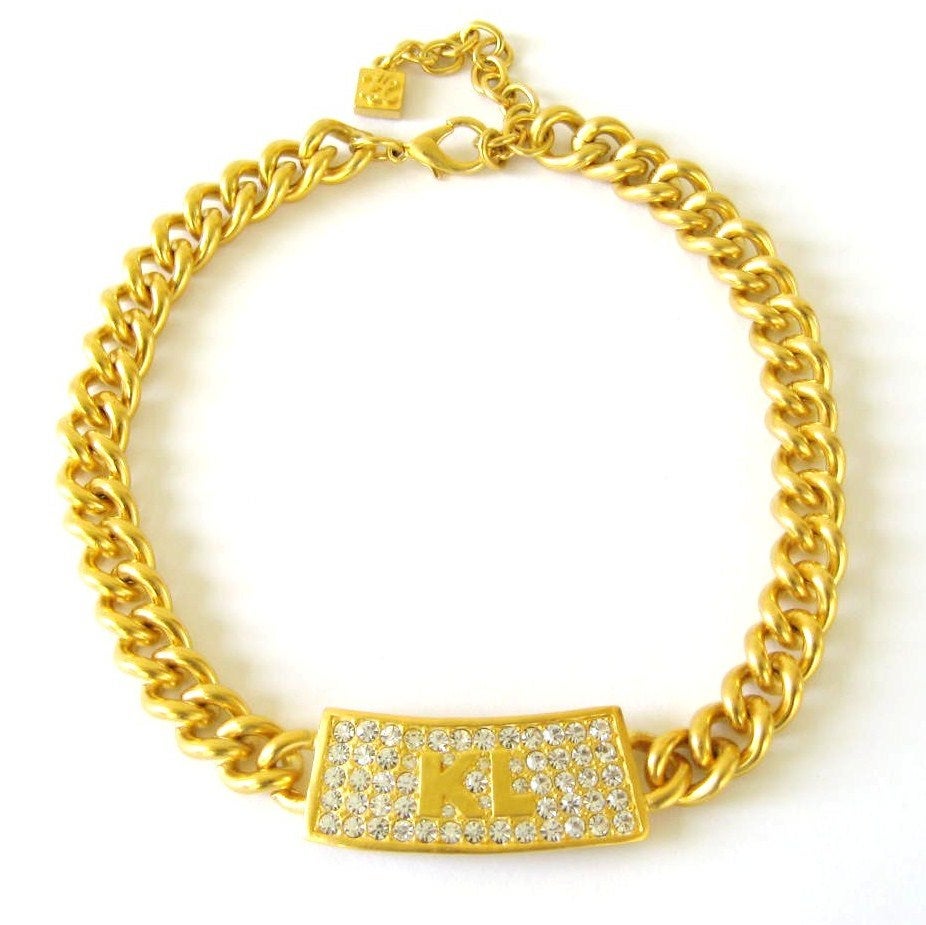 Stunning KL Gold Tone Necklace

Nice size on this statement piece. Large curb link chain. Pave set stones on front.

17.5