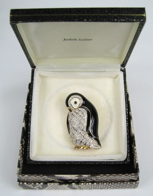 Judith Leiber Crystal & Enamel Penguin Brooch

Brand New in original jewel case with original box.
This pin has never been worn or removed from it's original case. 
Measures 3.5