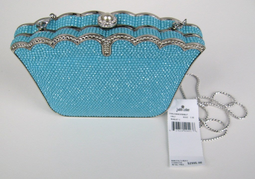Turquoise in color with a sea of Crystals by Judith Leiber
Leather Lined
Scalloped silver edge. Stunning in person

Measuring 6.5