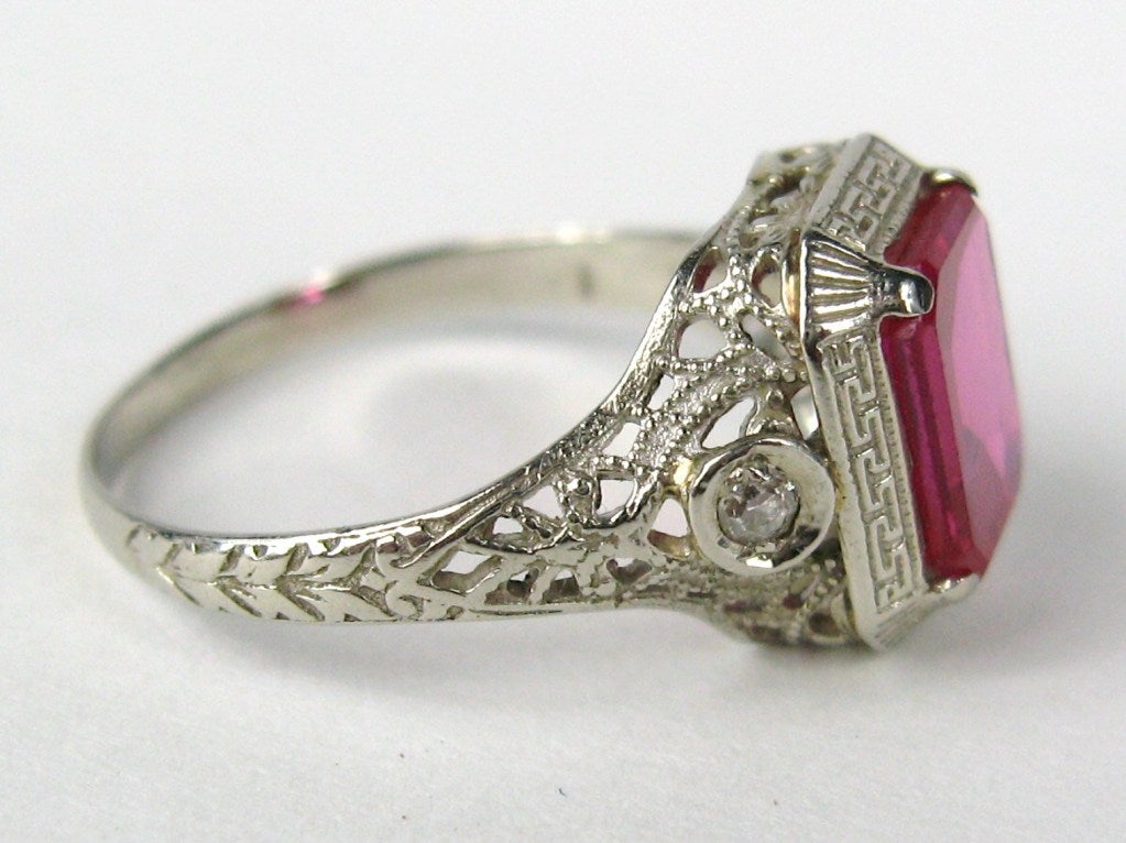Lovely 1920's White Gold Ring
Red Stone, is beryl Diamonds on each side
Ring is a size 6.5