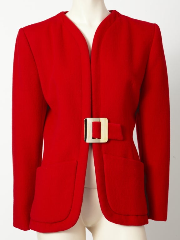 Pauline Trigere, red, wool, collarless, fitted jacket with cut away shape, large deep hip pockets and large rectangular shape gold metal buckle closure.