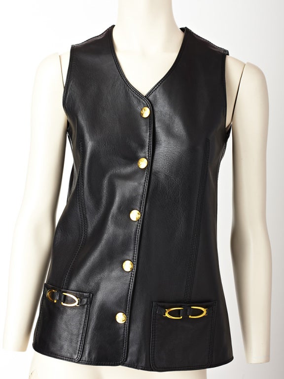 Celine, black leather vest with brass tone snap closures and horse
bit hardware detail on hip pockets.