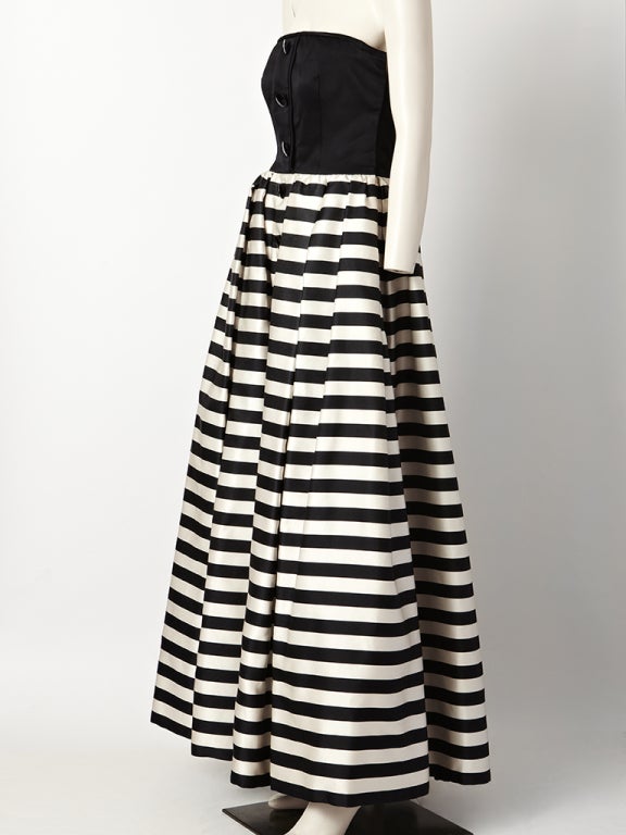 Valentino duchess satin gown, with fitted strapless bodice and full gathered black and white horizontal stripe skirt.