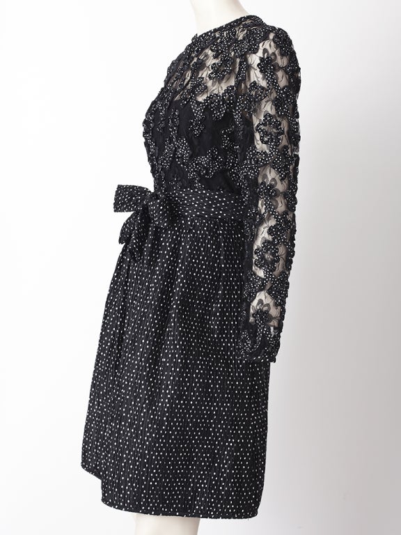Stanley Patos, black and white polka dot cocktail dress  with a lace bodice, embroidered with polka dot soutach. Skirt is slightly gathered with a sculpted bow at the waist.