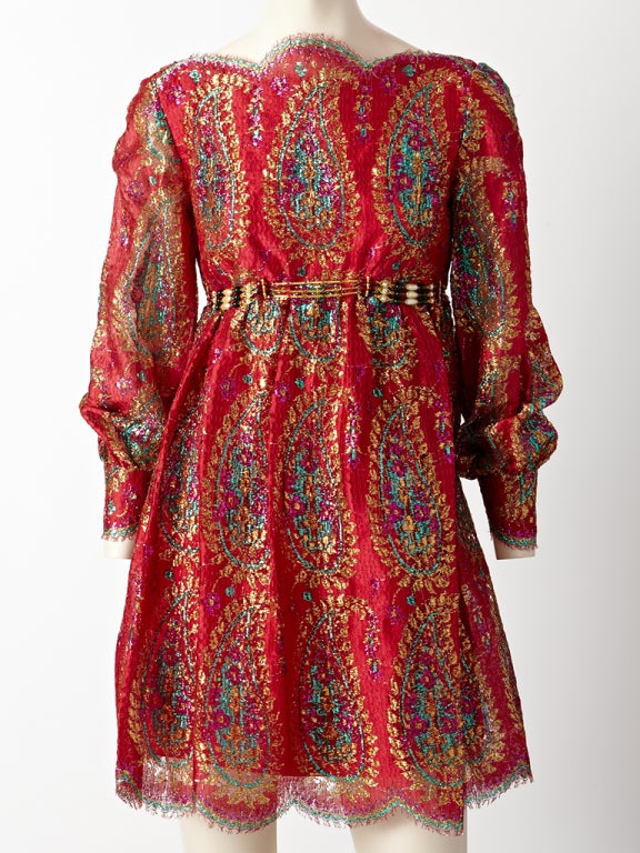 Bill Blass for Maurice Rentner, red, lace and lurex dress with giant paisley pattern embellishment. Long full sleeves with a bateau, scalloped neckline,empire waist, with a jeweled belt and a scallop hem.