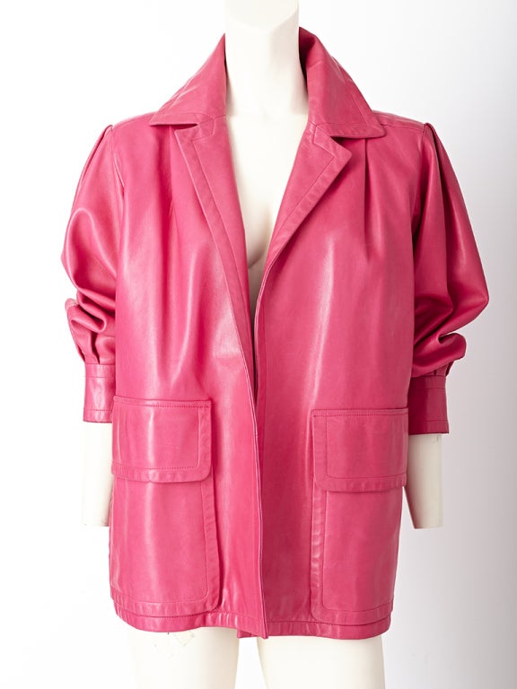 Yves Saint laurent, fuchsia, leather jacket with a strong 80's 
shoulder and full sleeves that end in a deep cuff. Sleeves can be pushed up to create a dramatic shape.Collar is notched and sharp and can stand up. Jacket has no closures and is meant